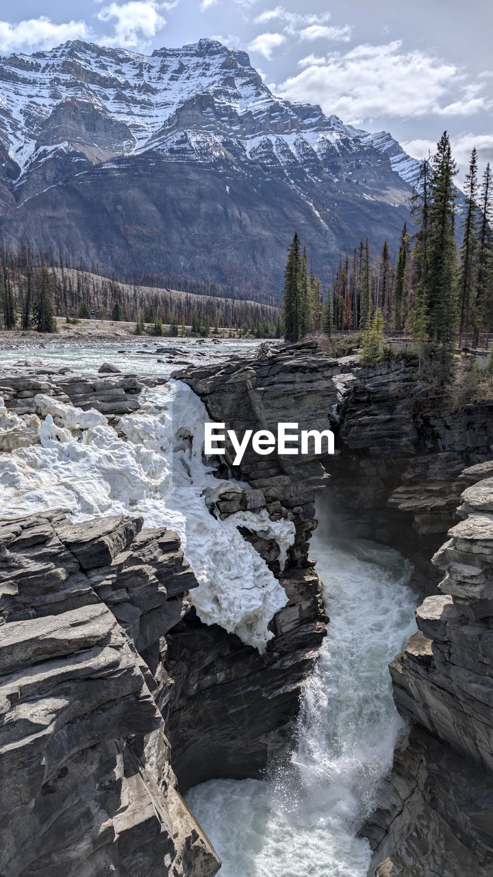 scenics - nature, mountain, snow, environment, wilderness, beauty in nature, cold temperature, water, landscape, nature, winter, land, tree, mountain range, sky, rock, forest, plant, no people, snowcapped mountain, travel destinations, cloud, travel, non-urban scene, pine tree, outdoors, valley, coniferous tree, ice, tranquil scene, tranquility, pinaceae, day, river, geology, tourism, moraine, pine woodland, rapid, ridge, mountain peak