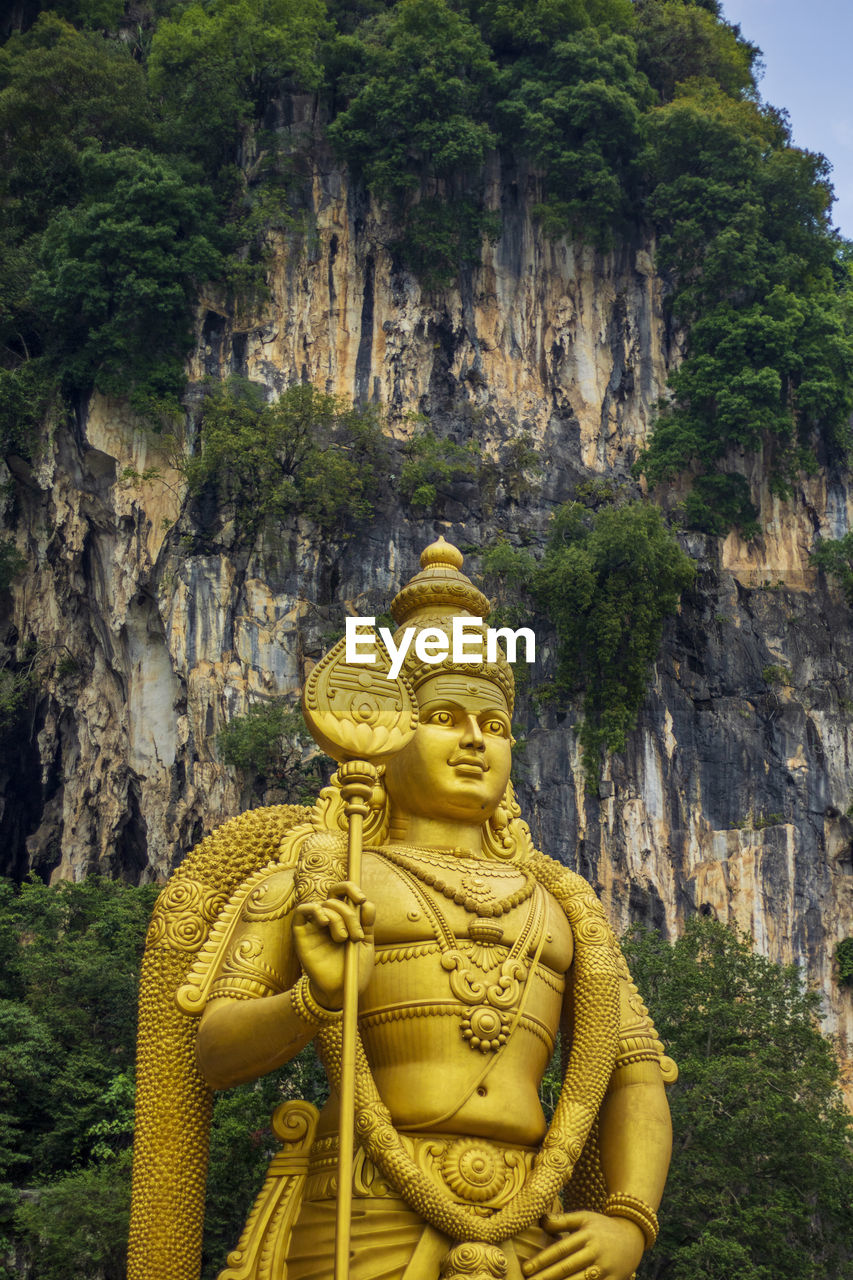 BUDDHA STATUE AGAINST TREES