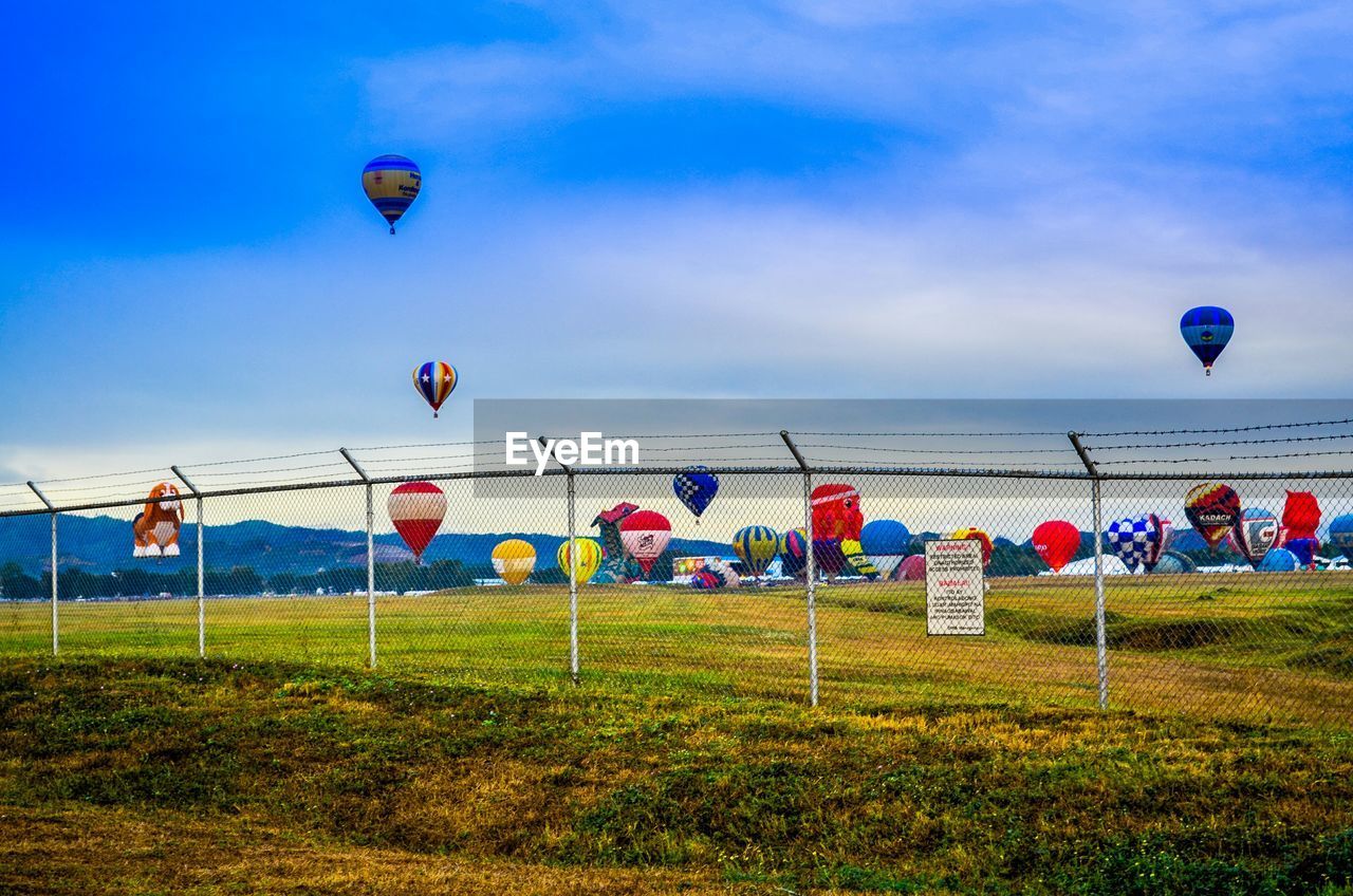 View of hot air balloons on countryside landscape