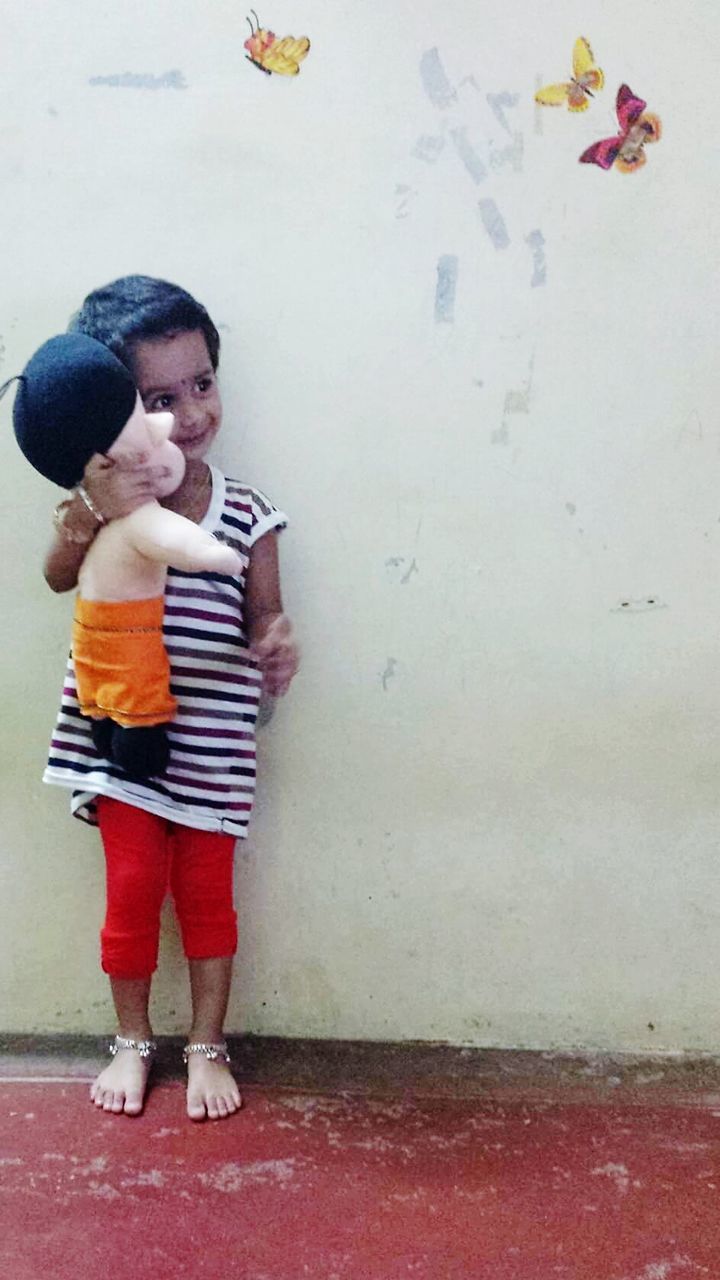 BOY STANDING AGAINST WALL