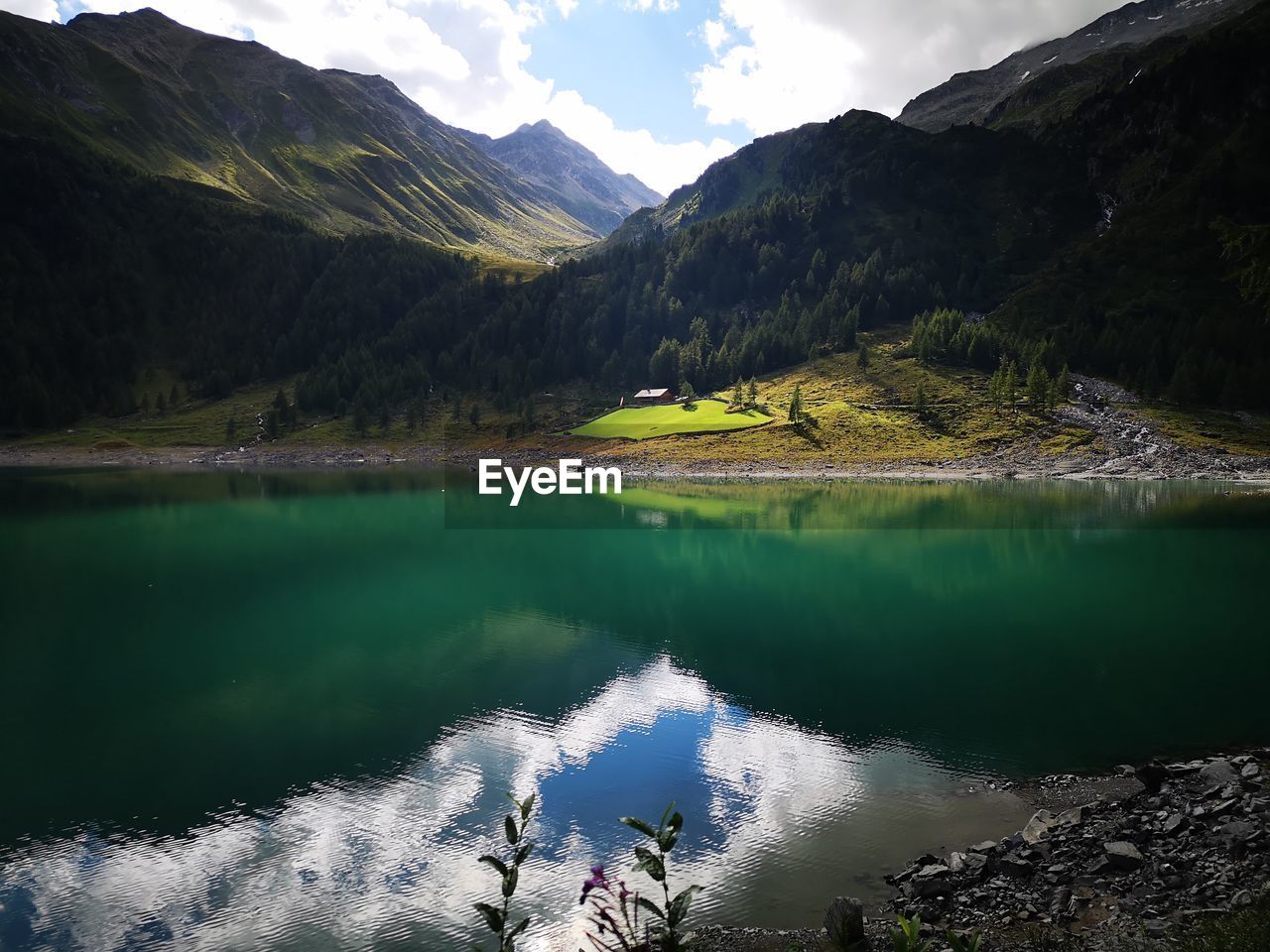 Scenic view of lake and mountains against sky