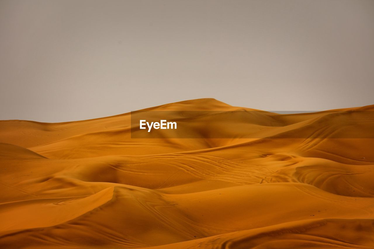 Scenic view of desert against clear sky