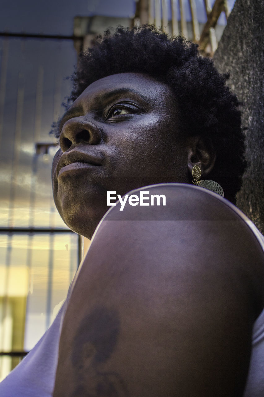 Close-up of woman with afro hair looking away