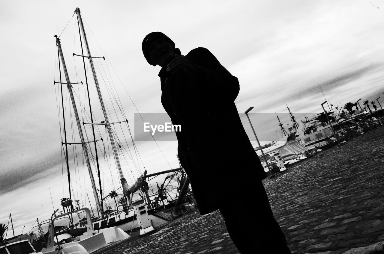 MAN PHOTOGRAPHING AT HARBOR
