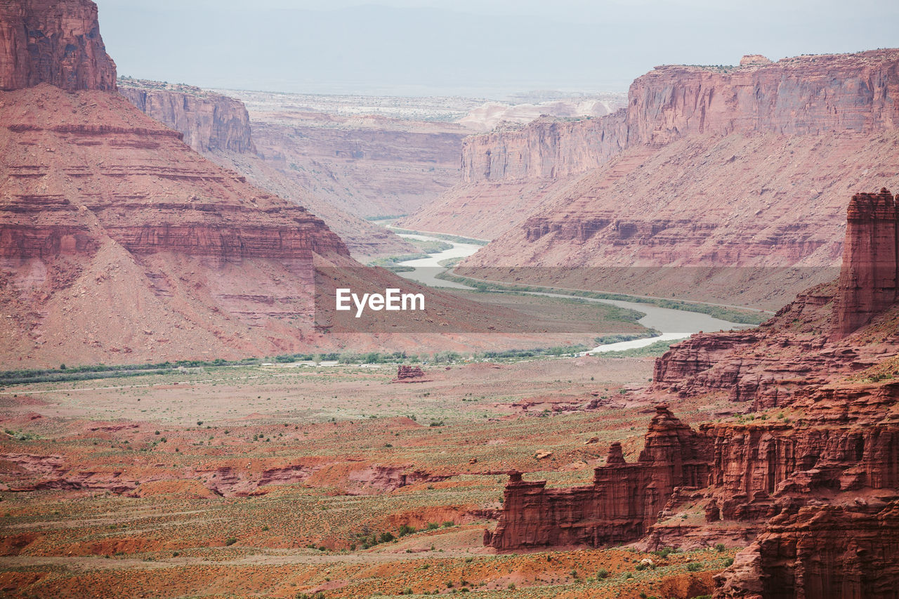 Red sandstone canyon walls and the colorado river near moab utah