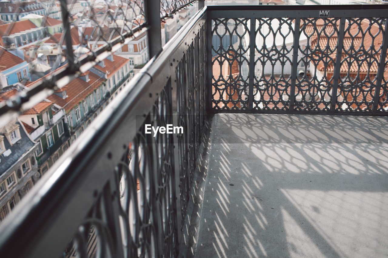 High angle view of railing and buildings in city