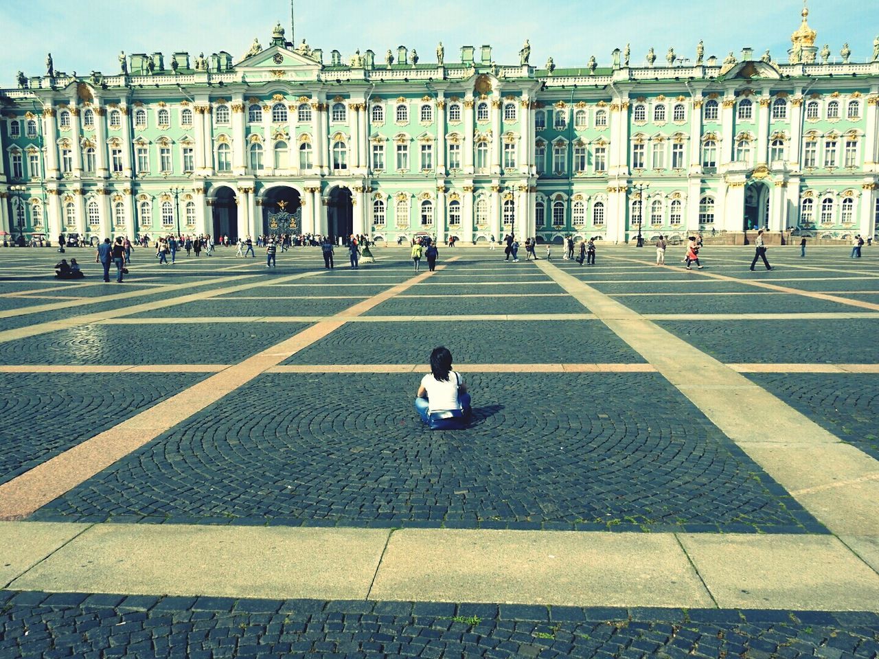 Rear view of woman sitting at palace square