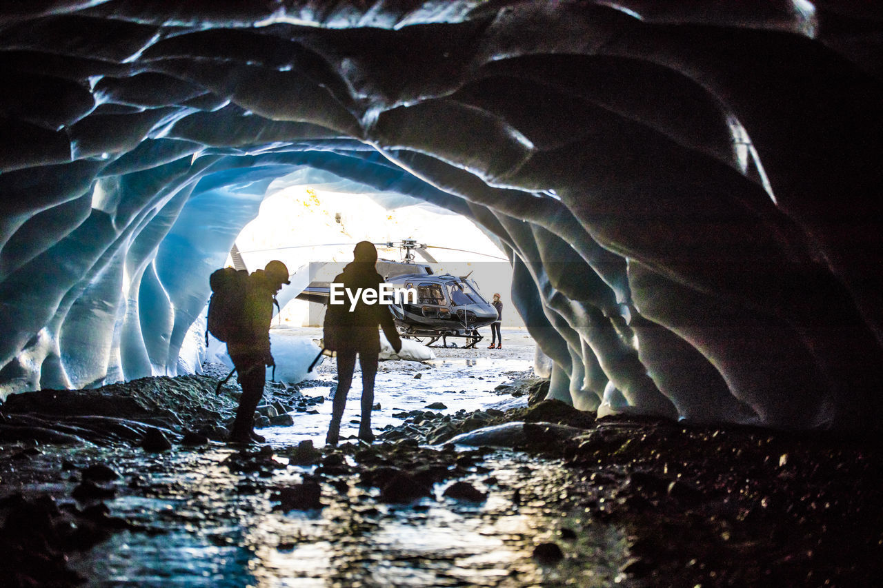 Helicopter tour brings couple to explore glacial cave.