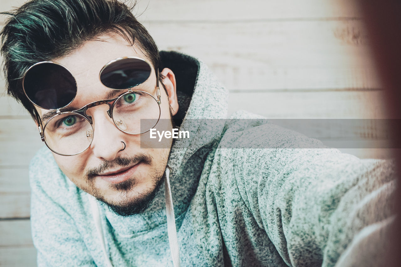 Close-up portrait of young man wearing sunglasses