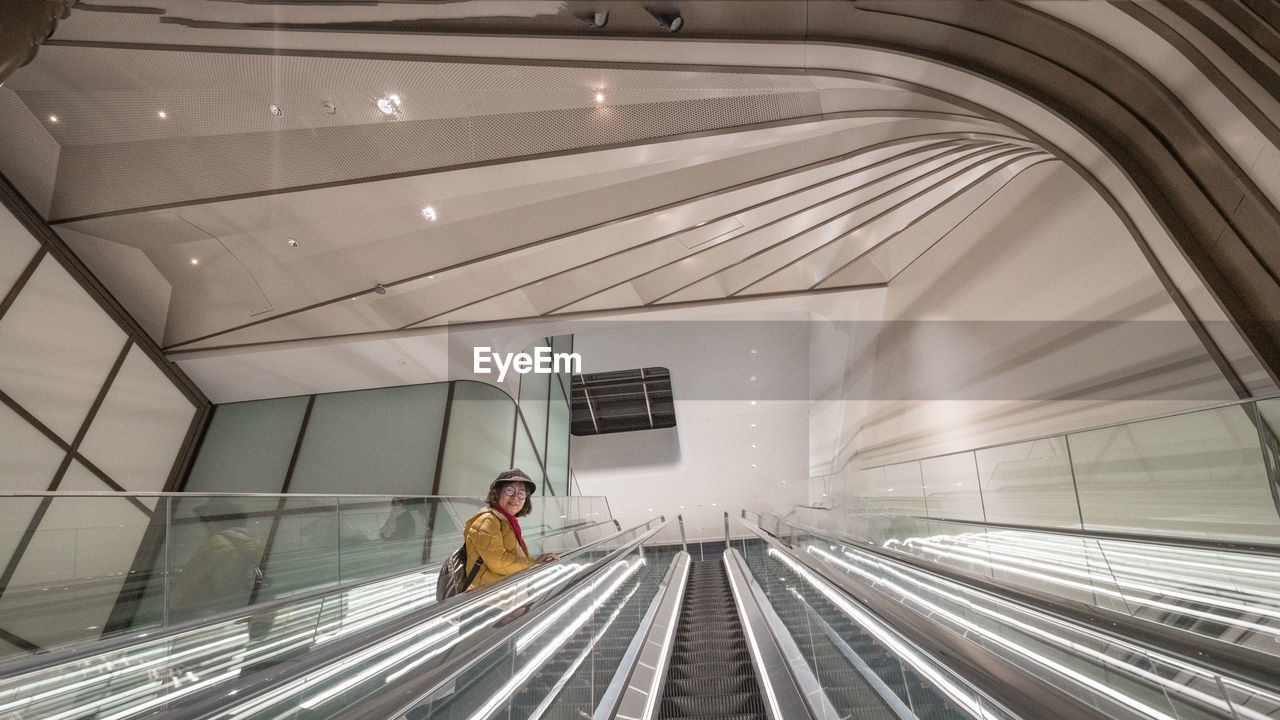 Low angle view of woman on the spiral staircase