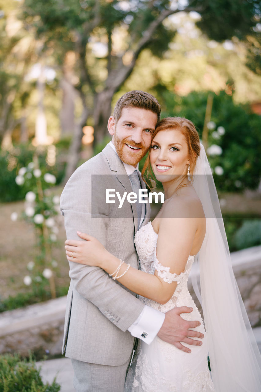 portrait of smiling couple holding hands