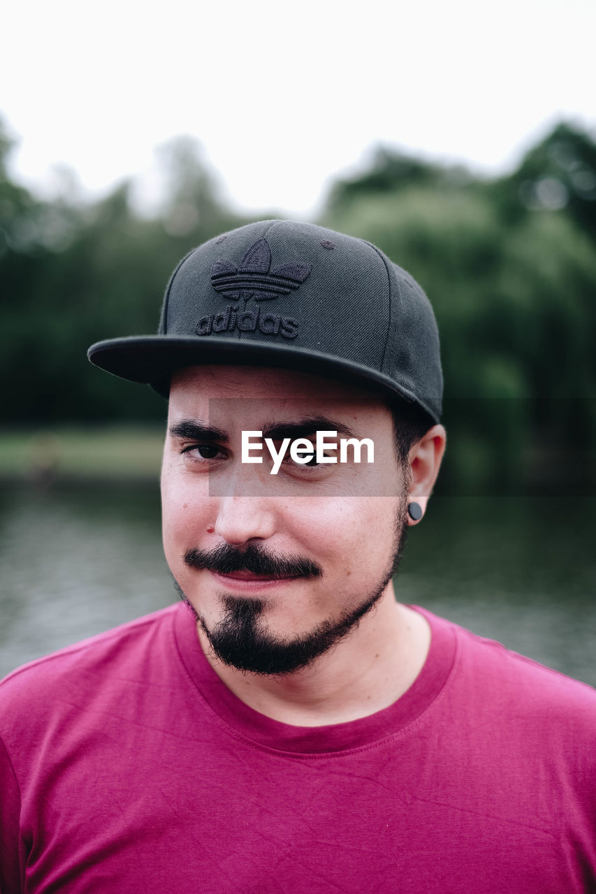 PORTRAIT OF YOUNG MAN WITH HAT IN WATER