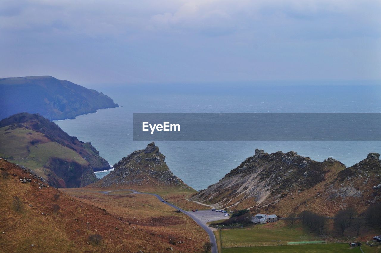 Scenic view of mountains and sea against sky