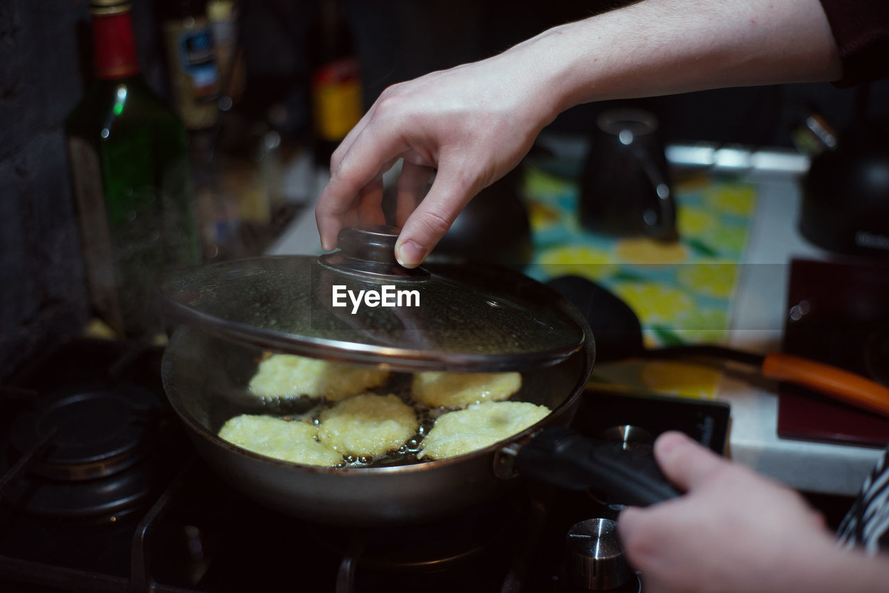 Cropped hand of woman preparing food at home