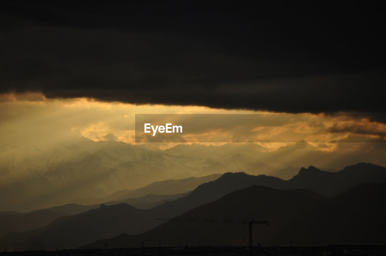 Scenic view of silhouette mountains against sky during sunset