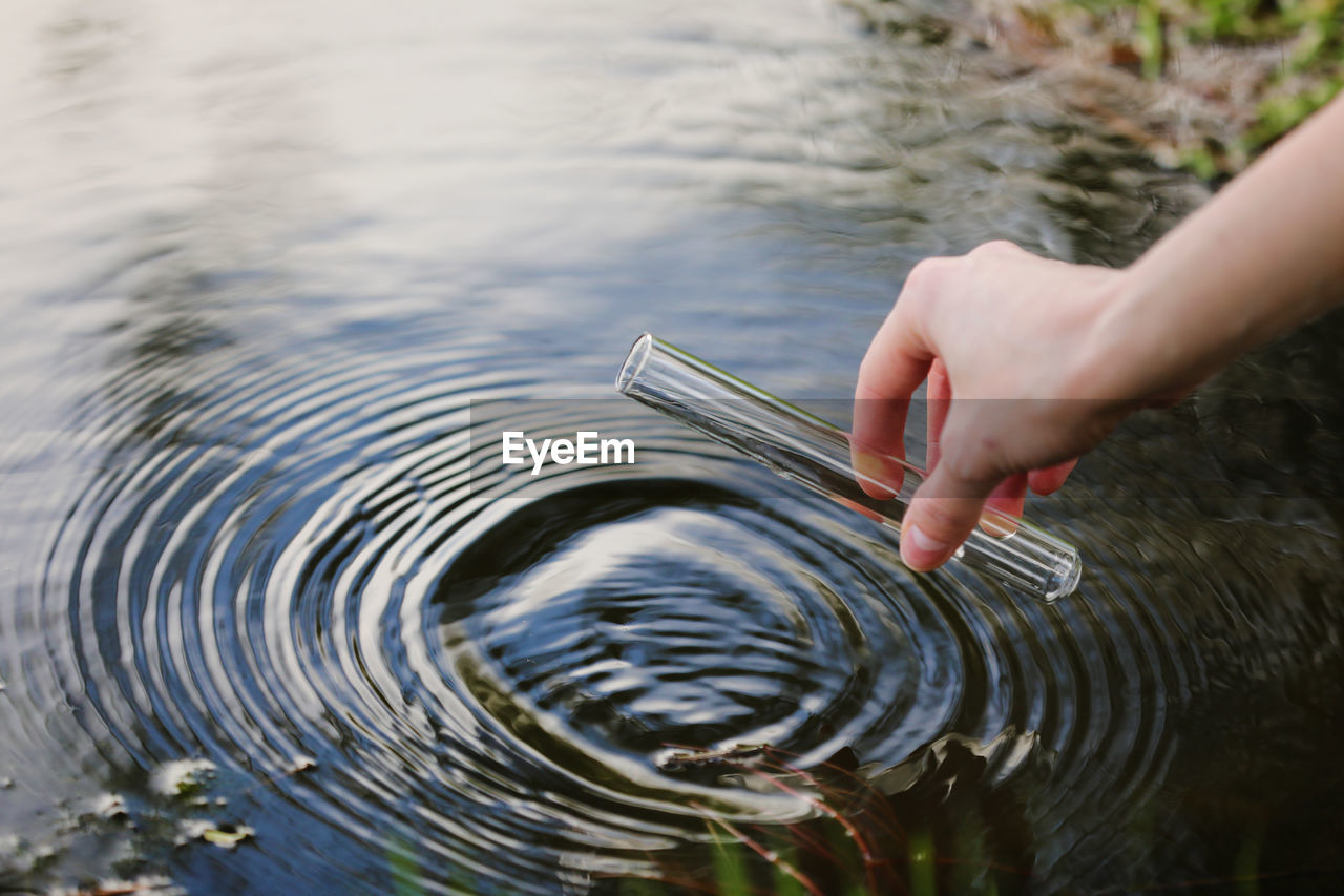 cropped hand of person holding water