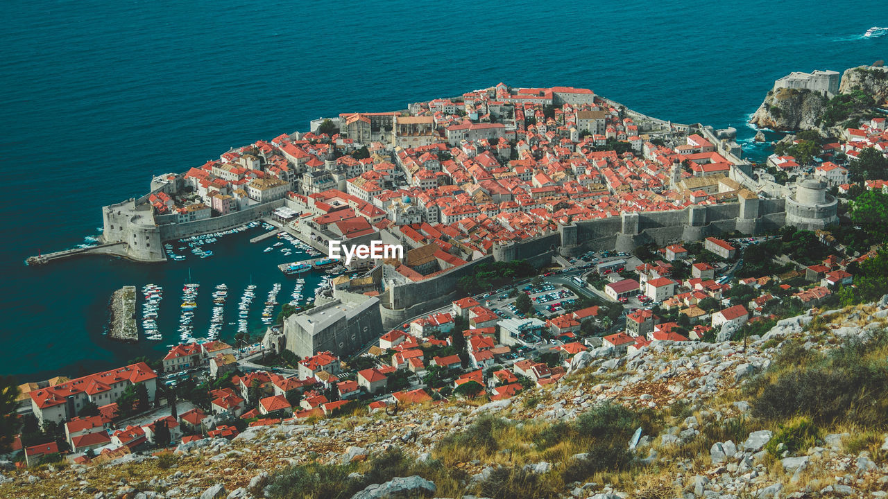 High angle view of townscape by sea