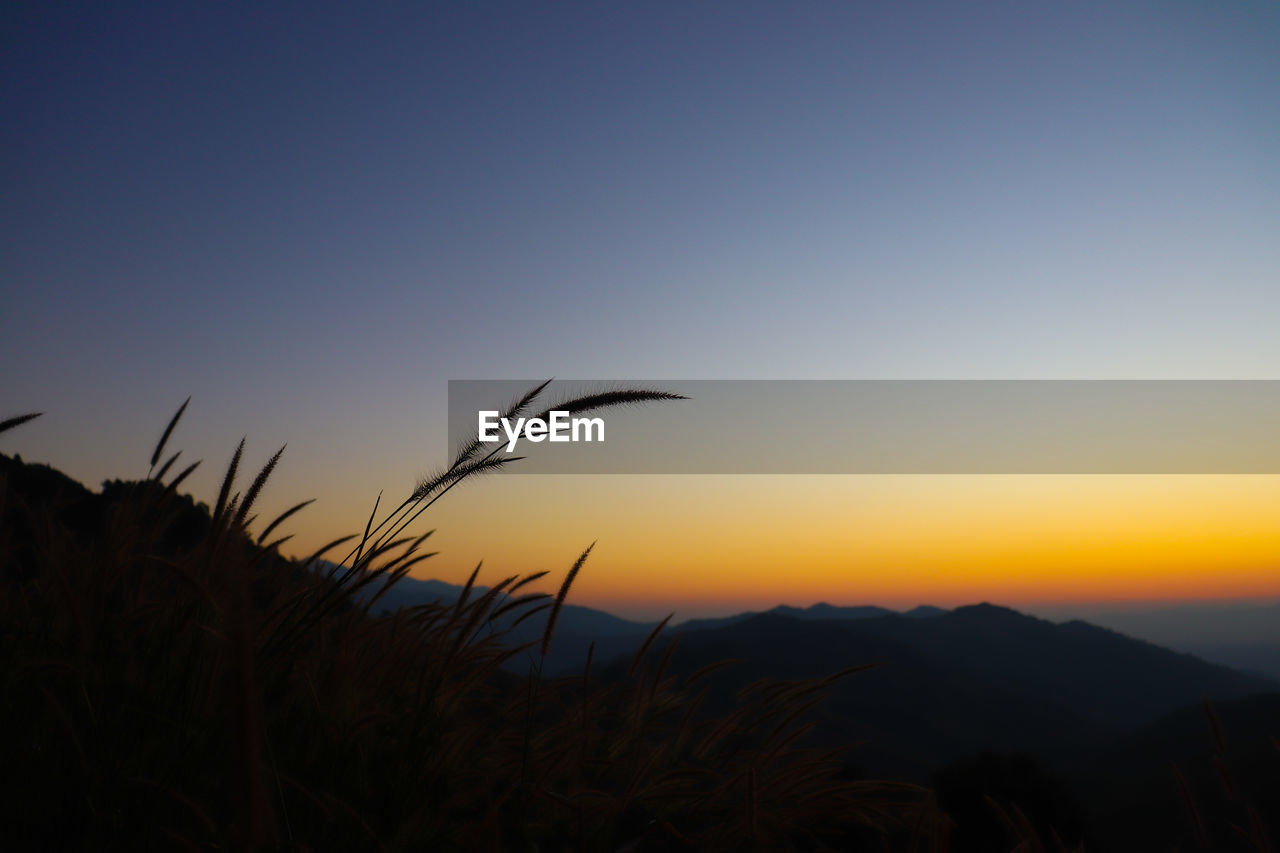 SCENIC VIEW OF SILHOUETTE LANDSCAPE AGAINST SKY DURING SUNSET