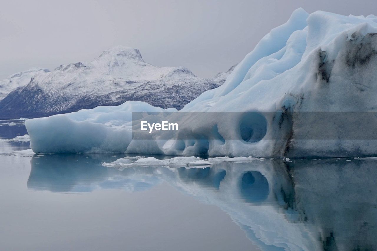 Scenic view of icebergs against clear waters 