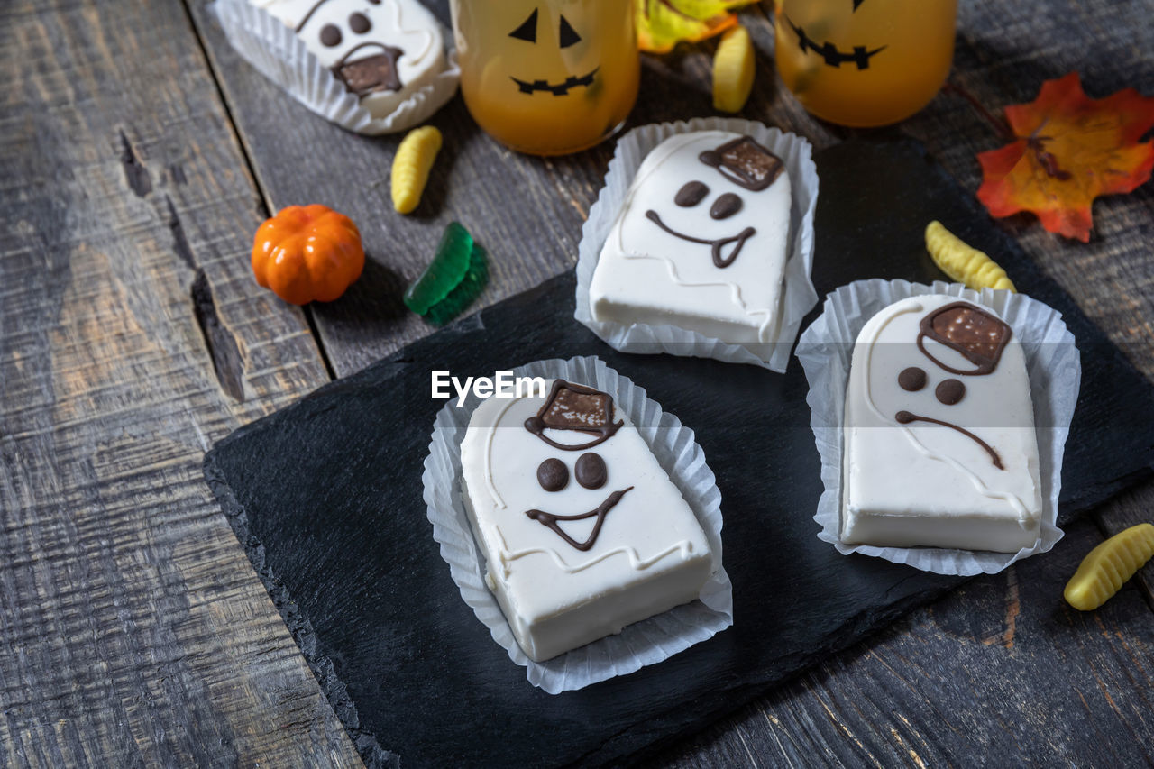 Homemade baked halloween party. funny cookies in white chocolate glaze ghost. 