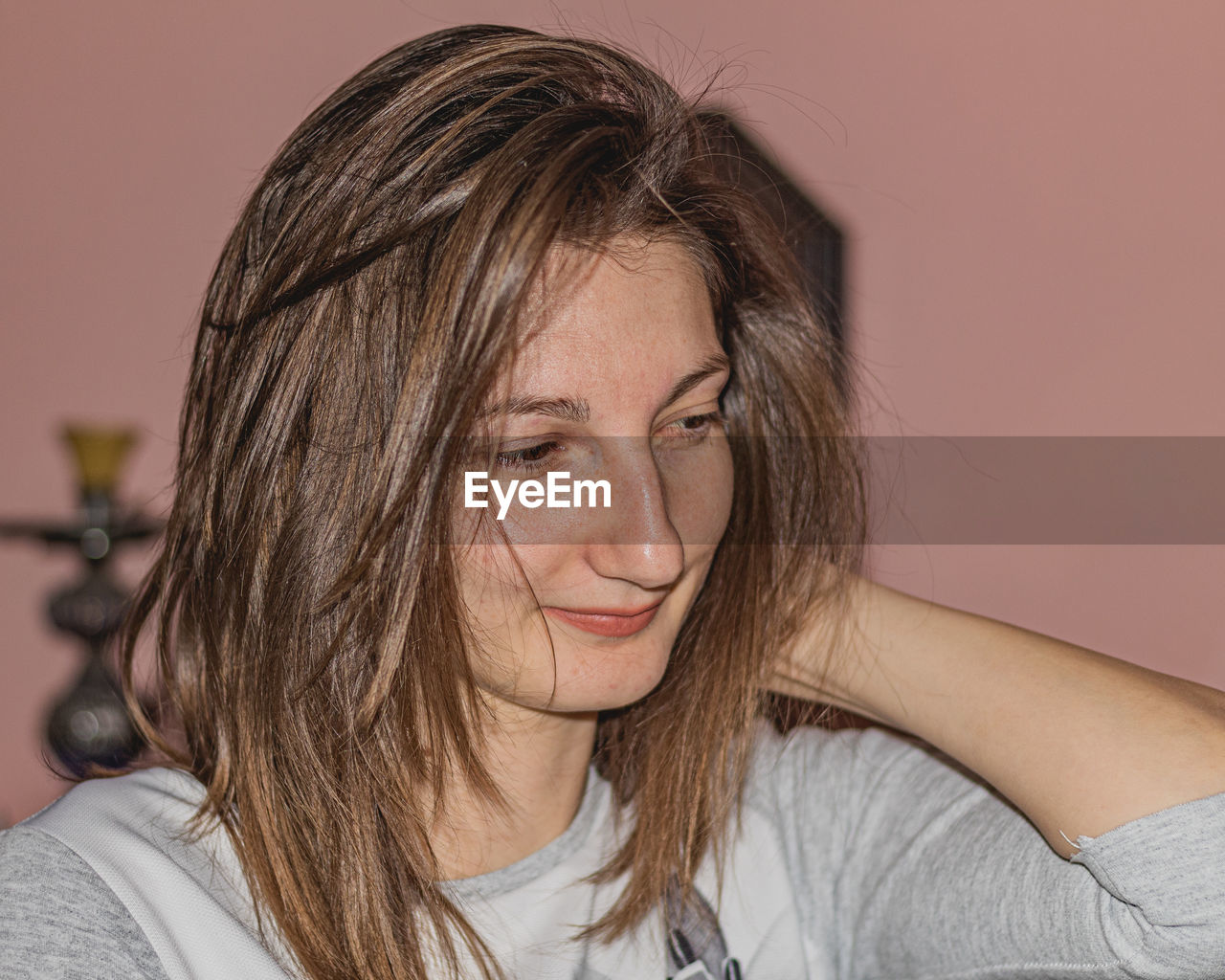 Close-up of smiling young woman at home