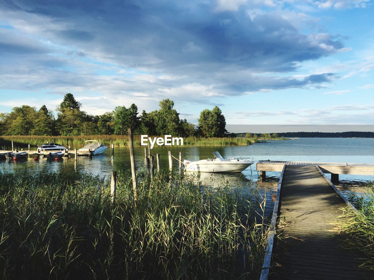 Jetty with boats by river
