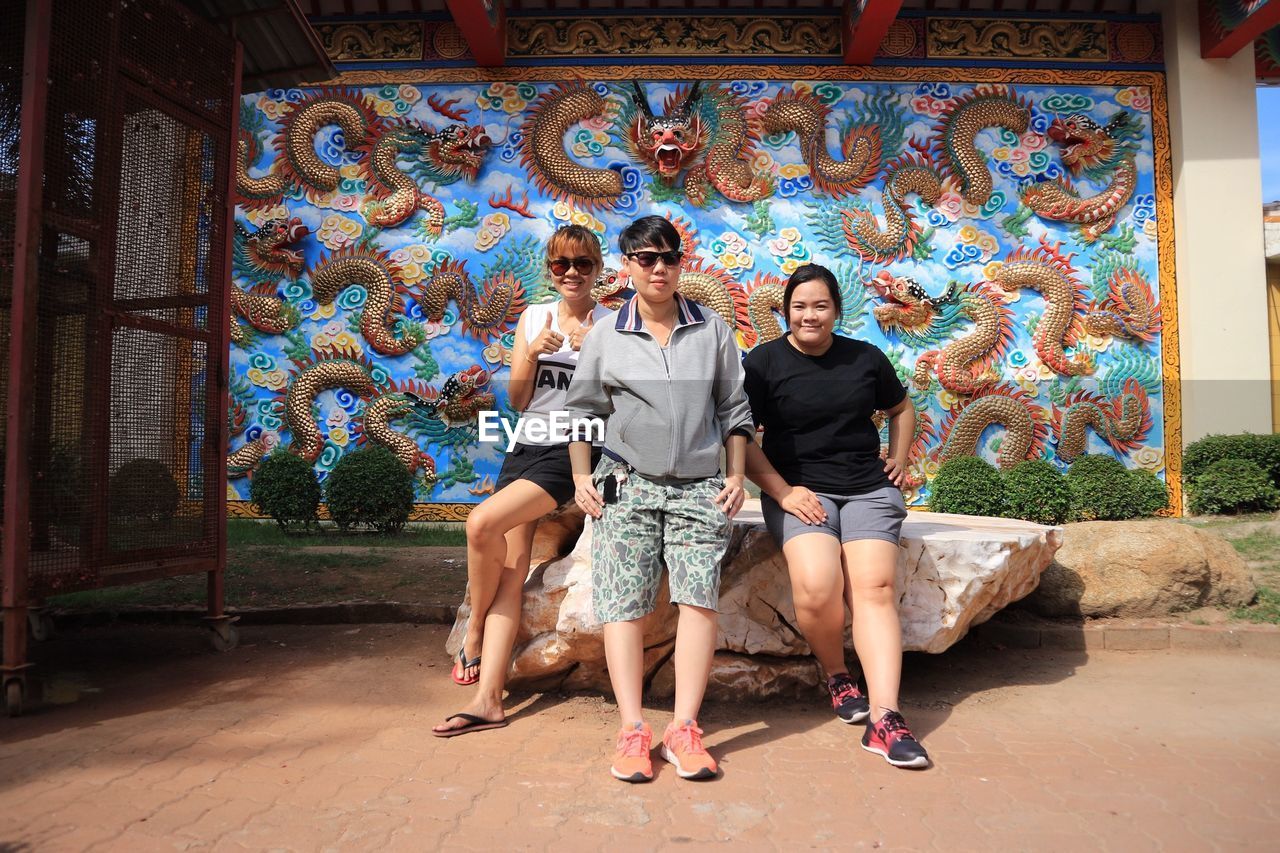 FULL LENGTH OF A YOUNG COUPLE ON WALL