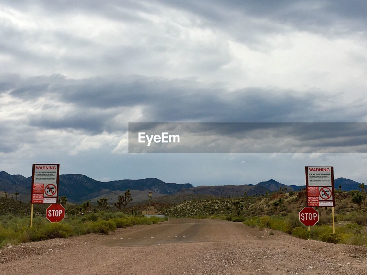 ROAD SIGN AGAINST CLEAR SKY ON MOUNTAIN