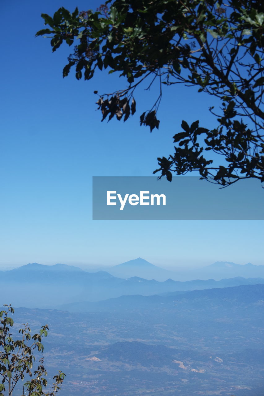 SCENIC VIEW OF MOUNTAIN AGAINST BLUE SKY