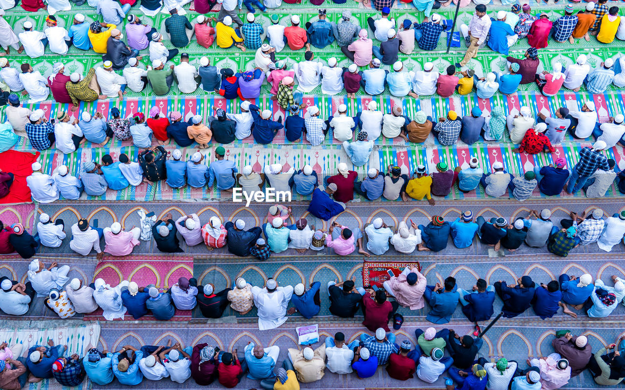 High angle view of men praying outdoors