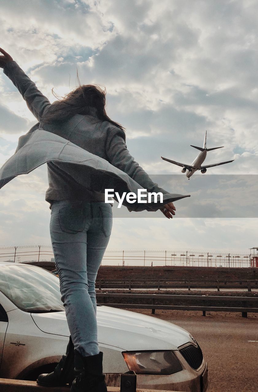 VIEW OF AIRPLANE FLYING OVER AIRPORT