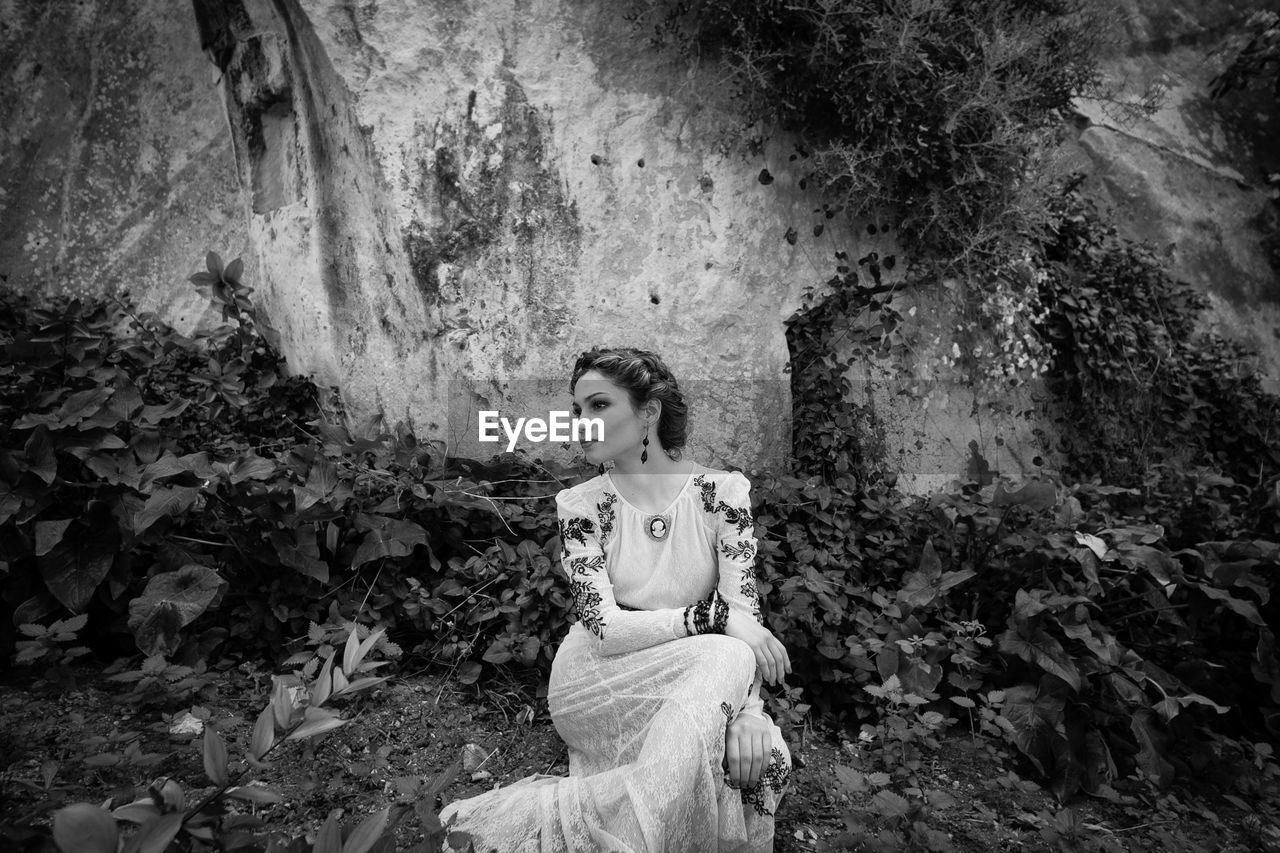 WOMAN LOOKING AT ROCKS