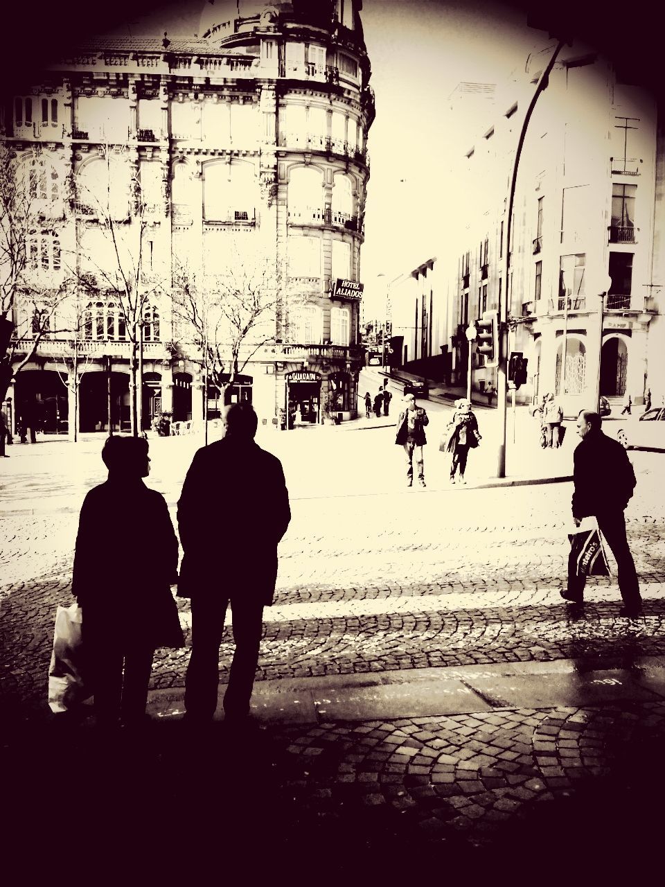 People on walkway by buildings