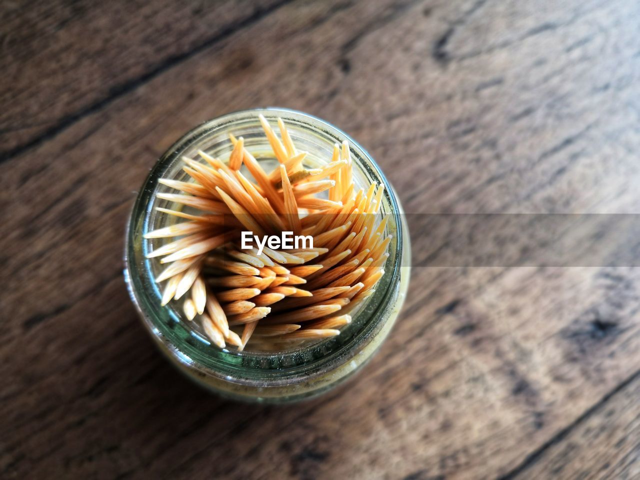 High angle view of toothpick in a  bottleon table