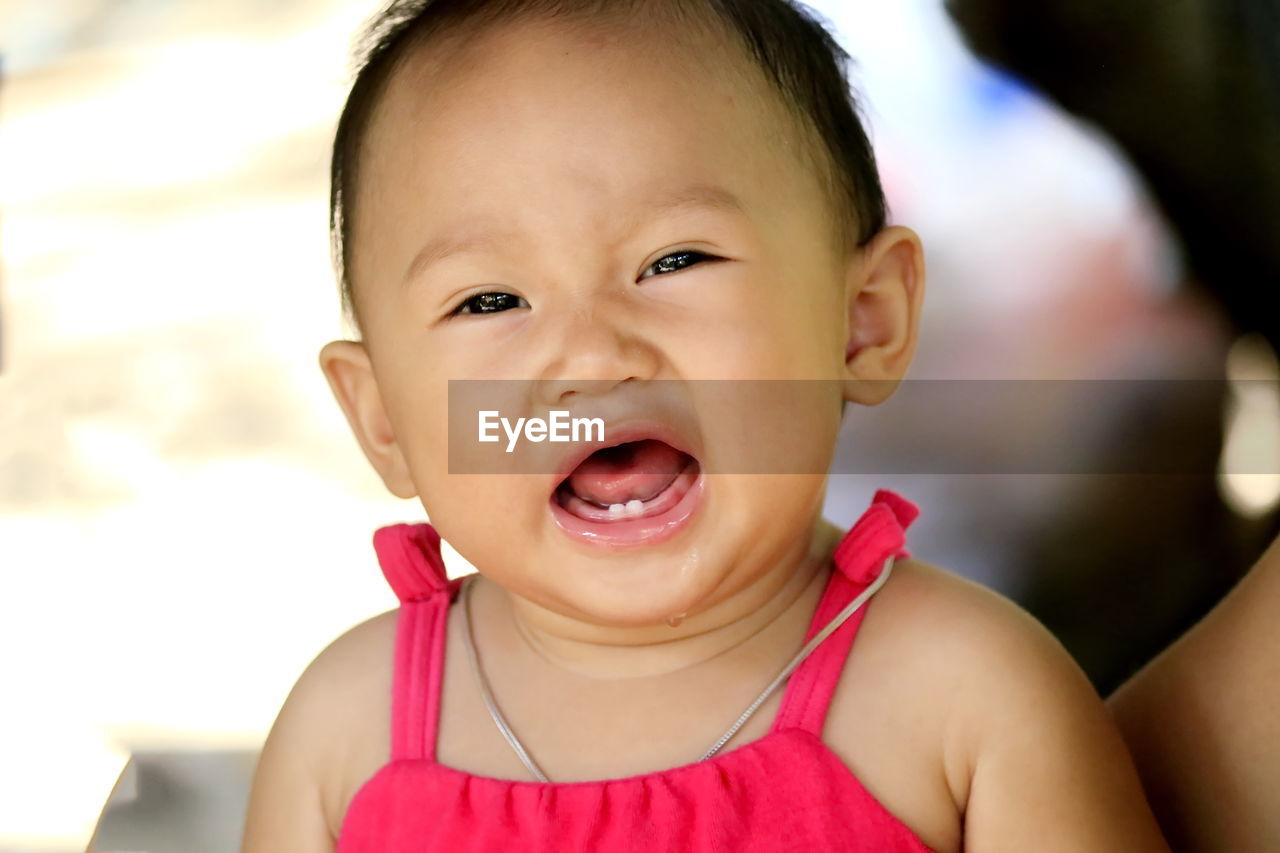 Portrait of cute baby girl crying outdoors