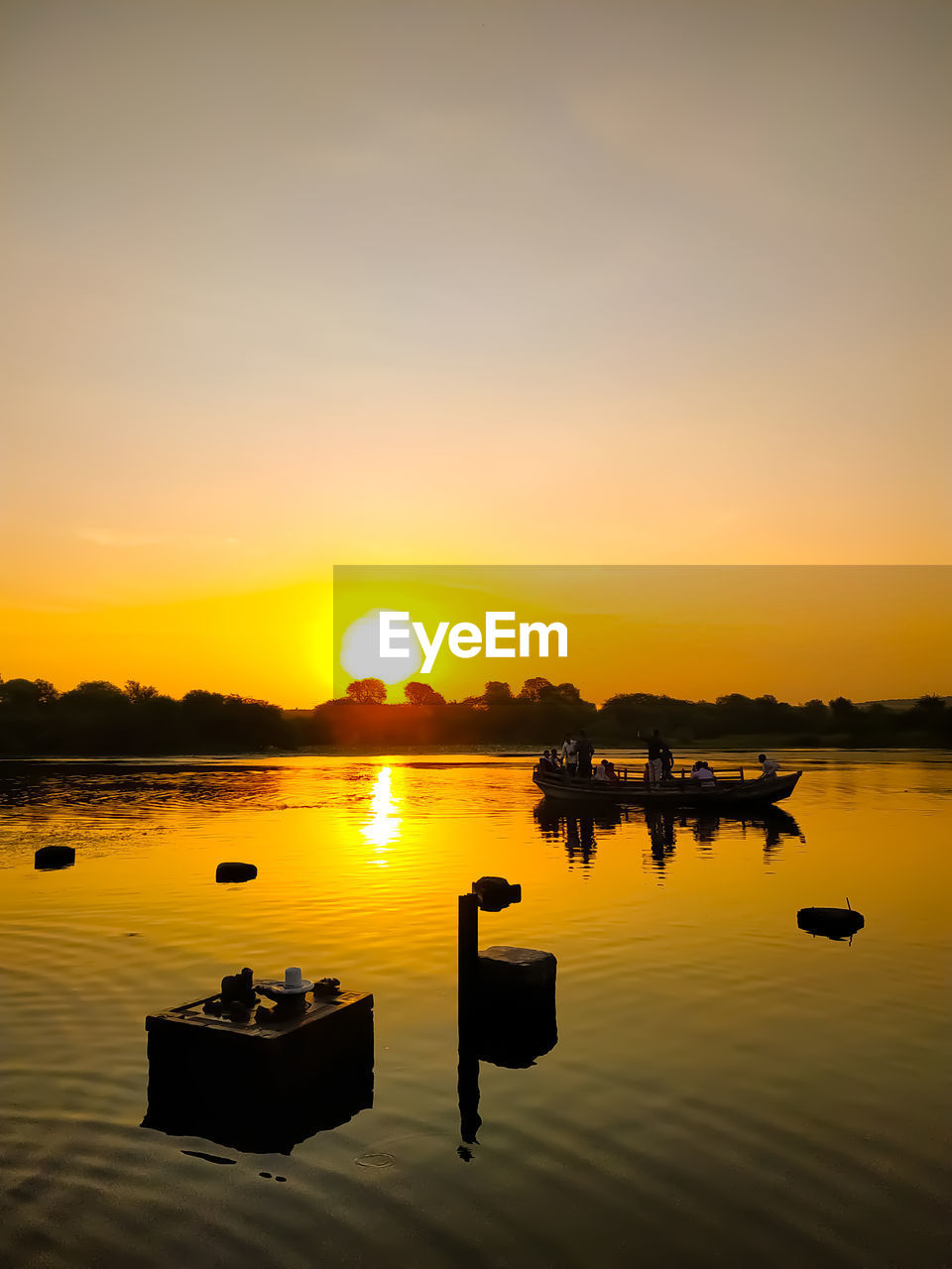 SCENIC VIEW OF LAKE AGAINST ORANGE SKY