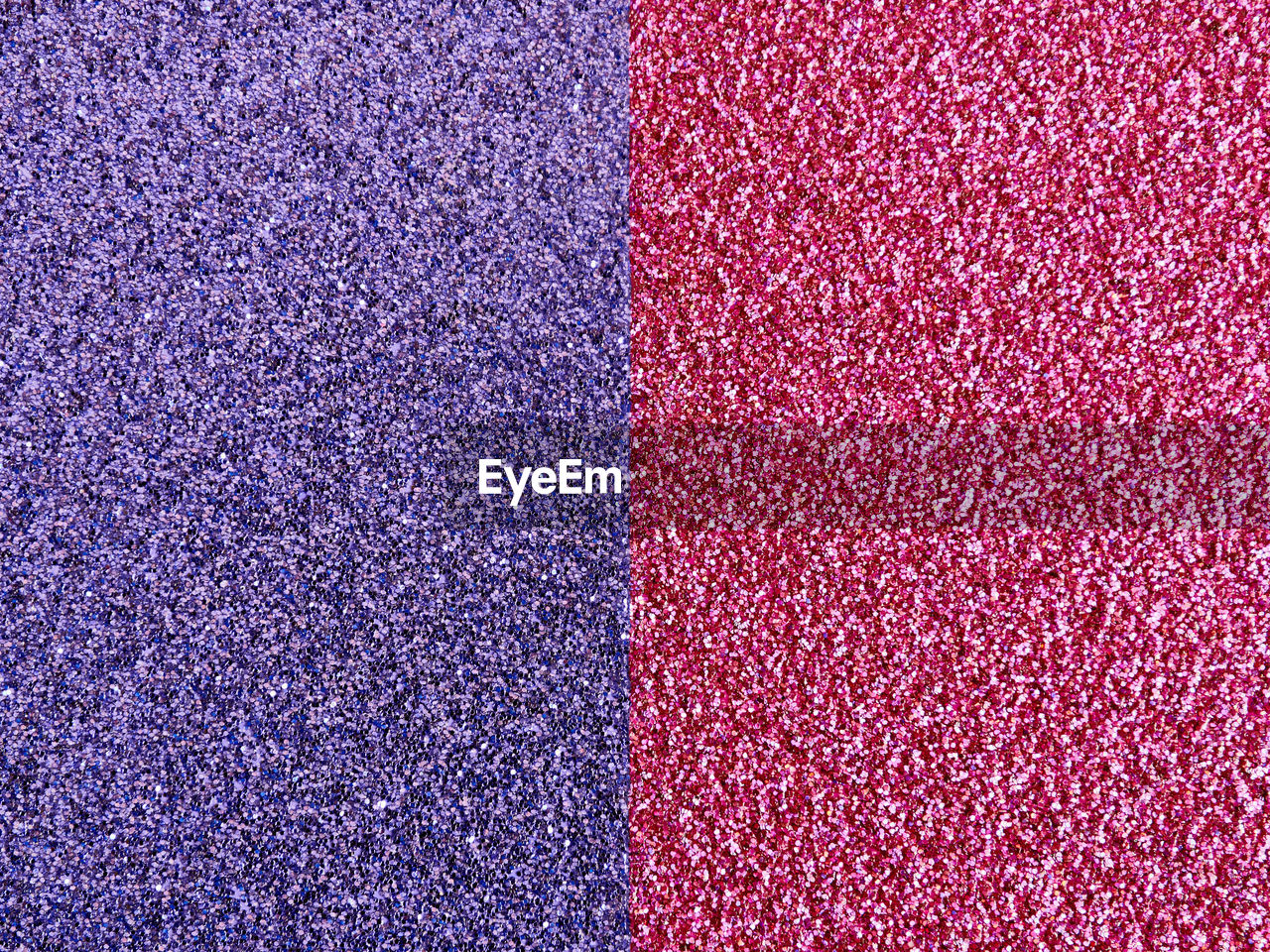 Purple and dark red glitter stripes vertical oriented background with texture. copy space. 