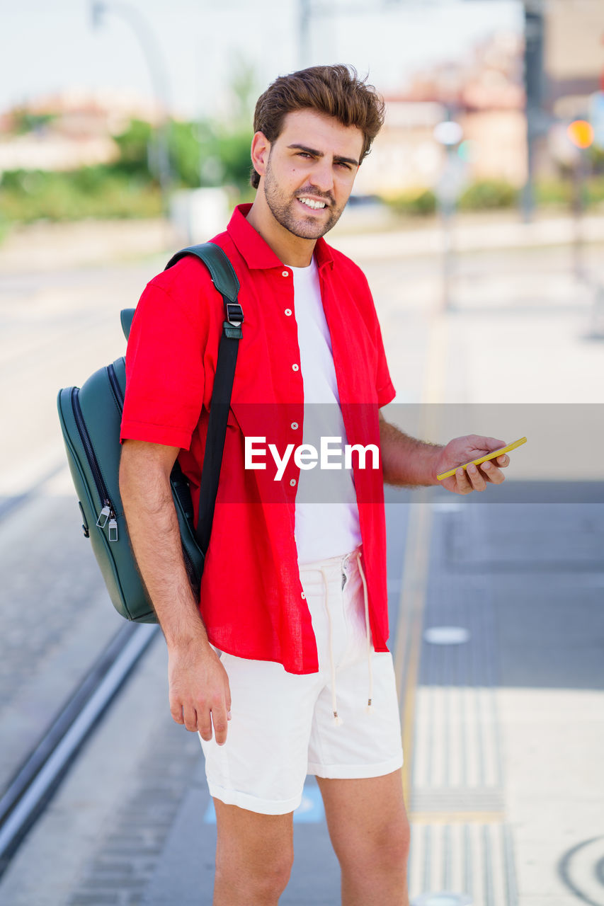 Portrait of smiling young man standing outdoors