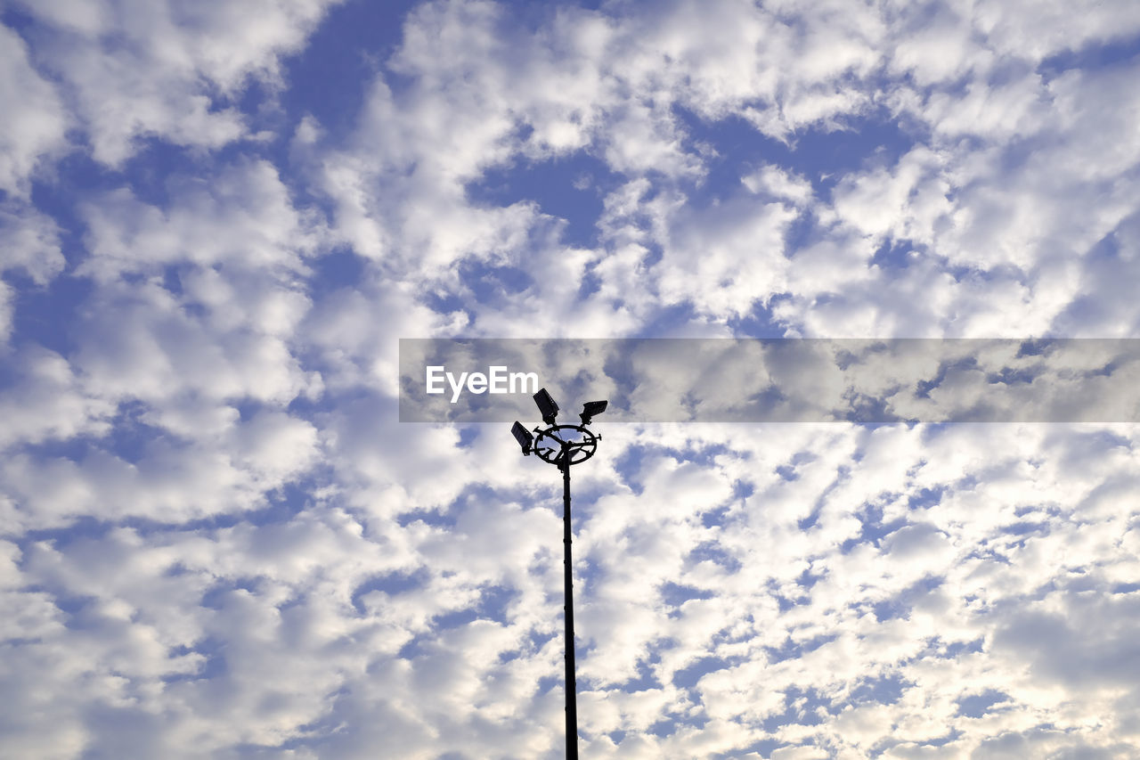 STREET LIGHT AGAINST CLOUDY SKY