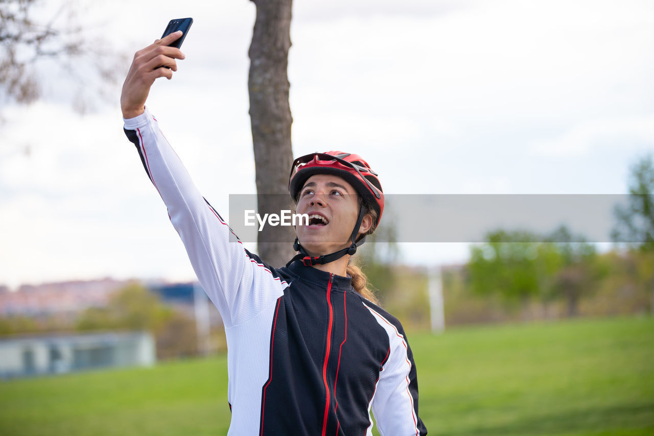 Male athlete taking selfie while standing park