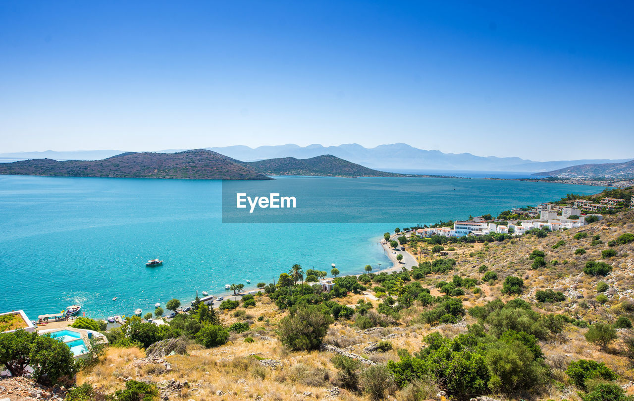 High angle view of bay against clear blue sky