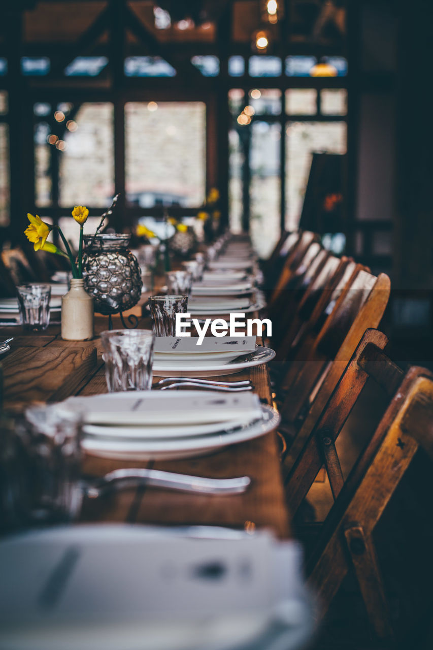 Plates and drinking glasses arranged on restaurant tables