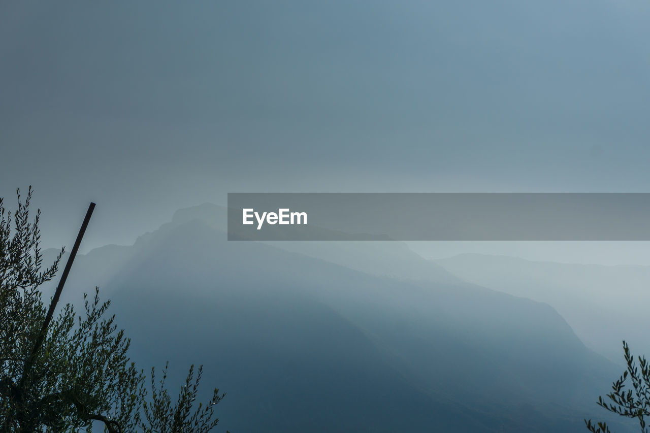 SCENIC VIEW OF TREE MOUNTAINS AGAINST SKY