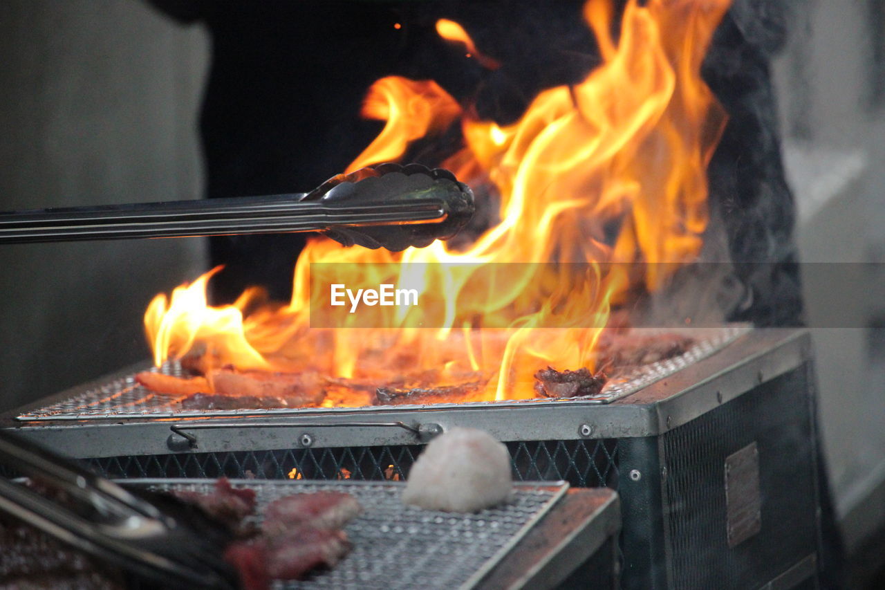 CLOSE-UP OF CAMPFIRE ON BARBECUE