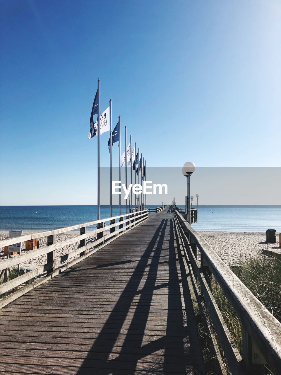 Pier over sea against clear sky