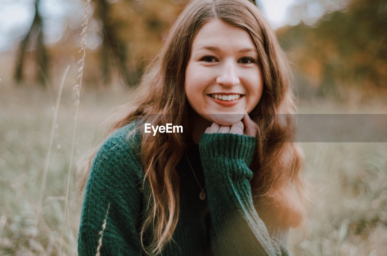 Portrait of smiling girl sitting on field