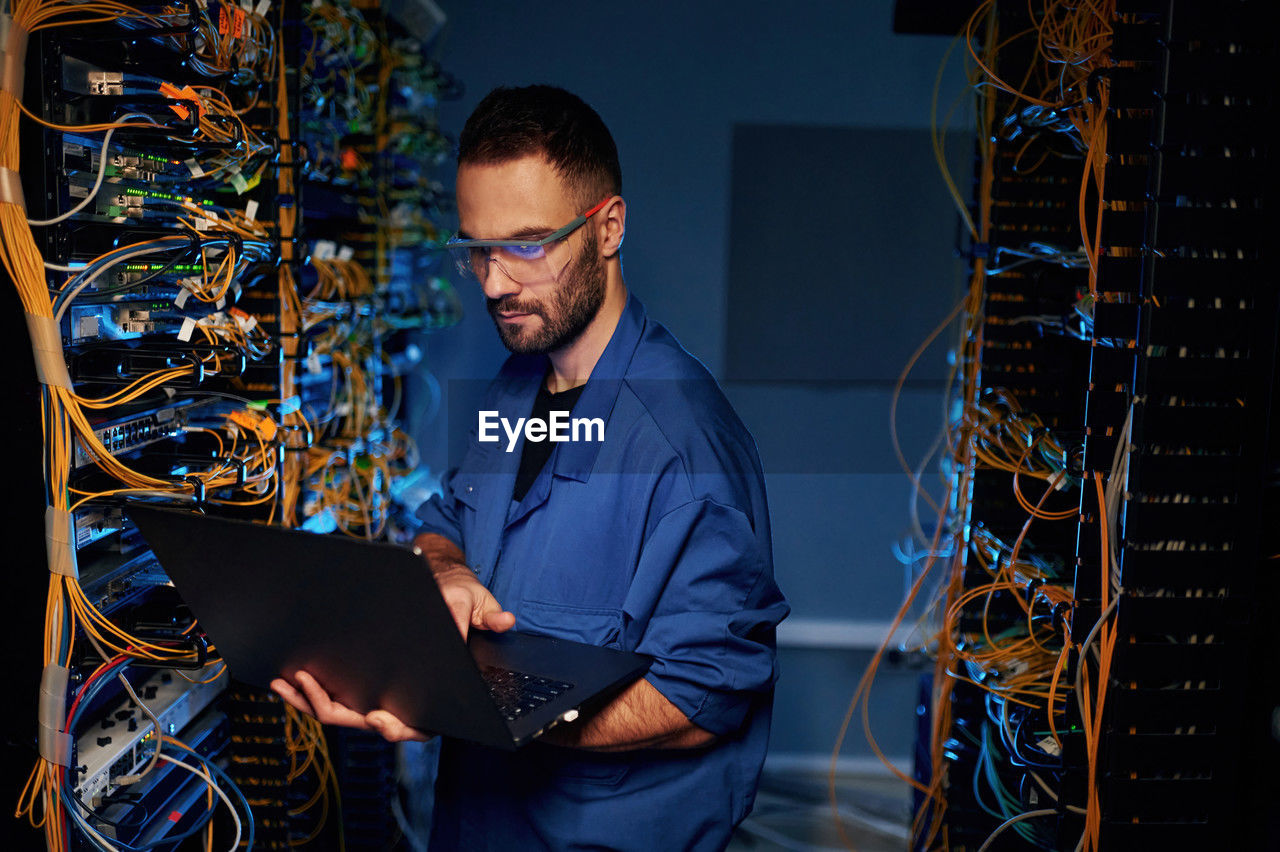 internet, computer network, technology, network server, wireless technology, computer, cable, communication, it support, adult, one person, men, using computer, business, computer cable, working, technician, office, glasses, programmer, occupation, businessman, network connection plug, computer equipment, global communications, eyeglasses, industry, indoors, professional occupation, expertise, electronics industry, equipment, corporate business, blue, security, network security, person, business finance and industry, engineering, mainframe, computer part, e-mail, desktop pc, protection, complexity, waist up, looking, electrical equipment