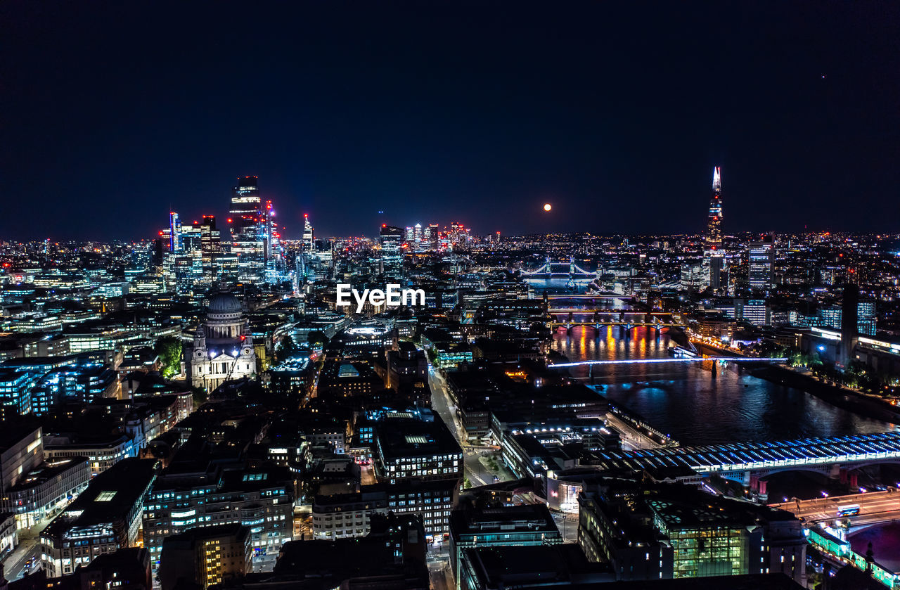 HIGH ANGLE VIEW OF ILLUMINATED CITY BUILDINGS