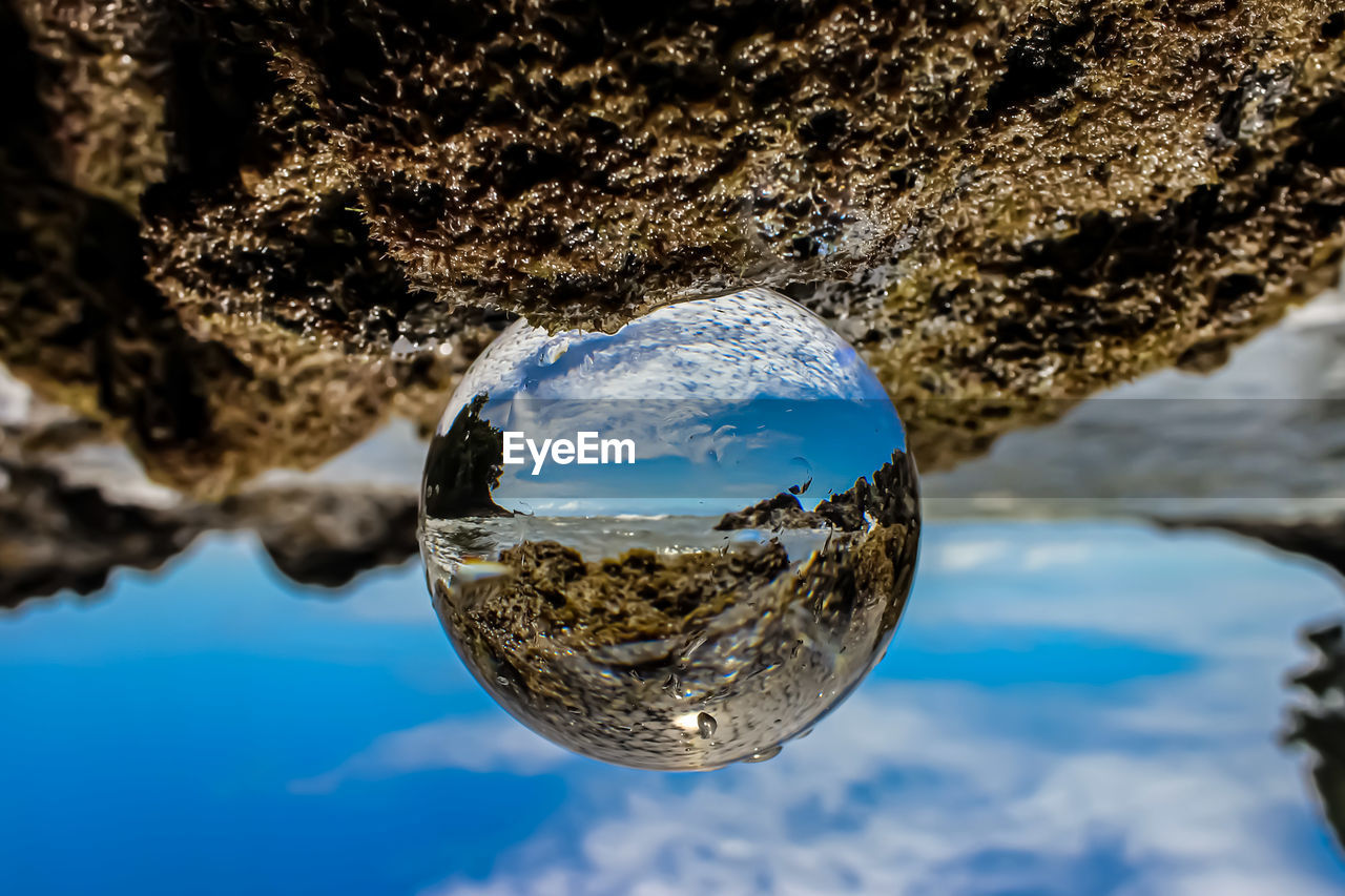 close-up of crystal ball on beach