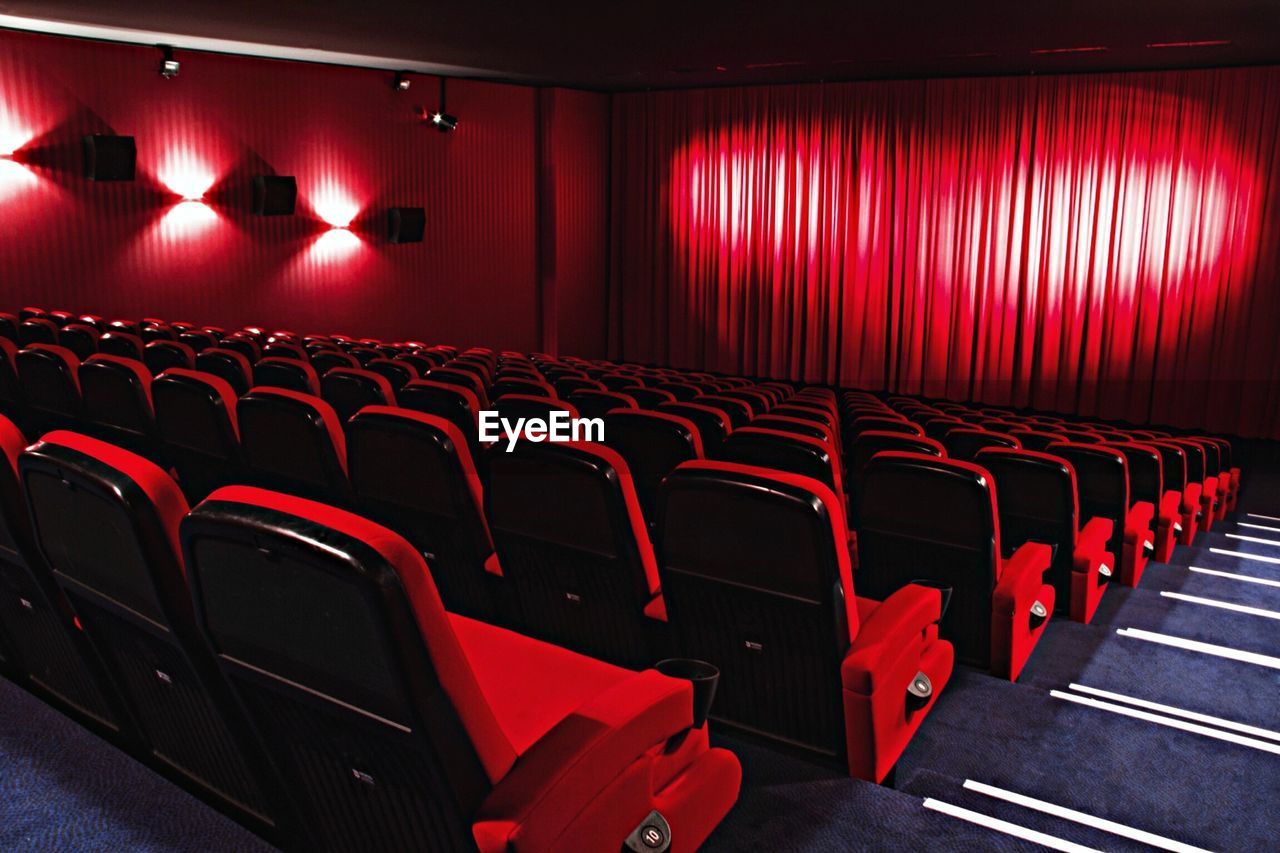 View of red chairs in auditorium